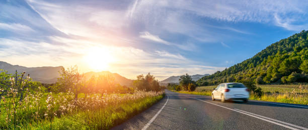 rental car in spain mountain landscape road at sunset - 車 ストックフォトと画像